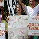 Protesters stand on the sidewalk outside a McDonald’s restaurant in Miramar, Fla., April 2, 2015, asking that the chain raise its wages to $15 an hour.
Joe Raedle/Getty Images